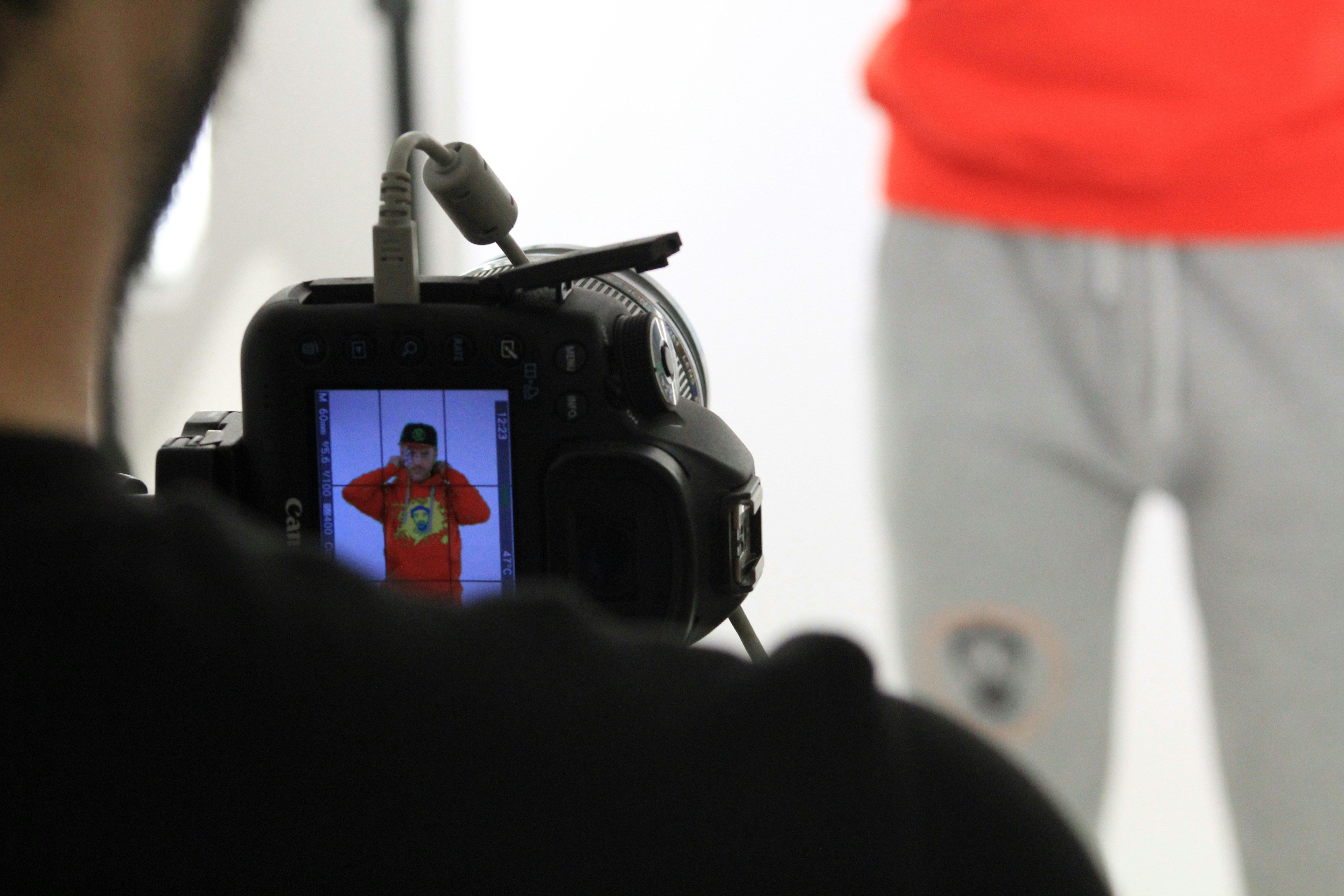 Behind the scenes shot of independent film production with crew operating camera and lighting equipment on intimate set